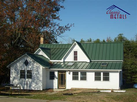 green metal roof on bsrn shaped house|dark green metal roof.